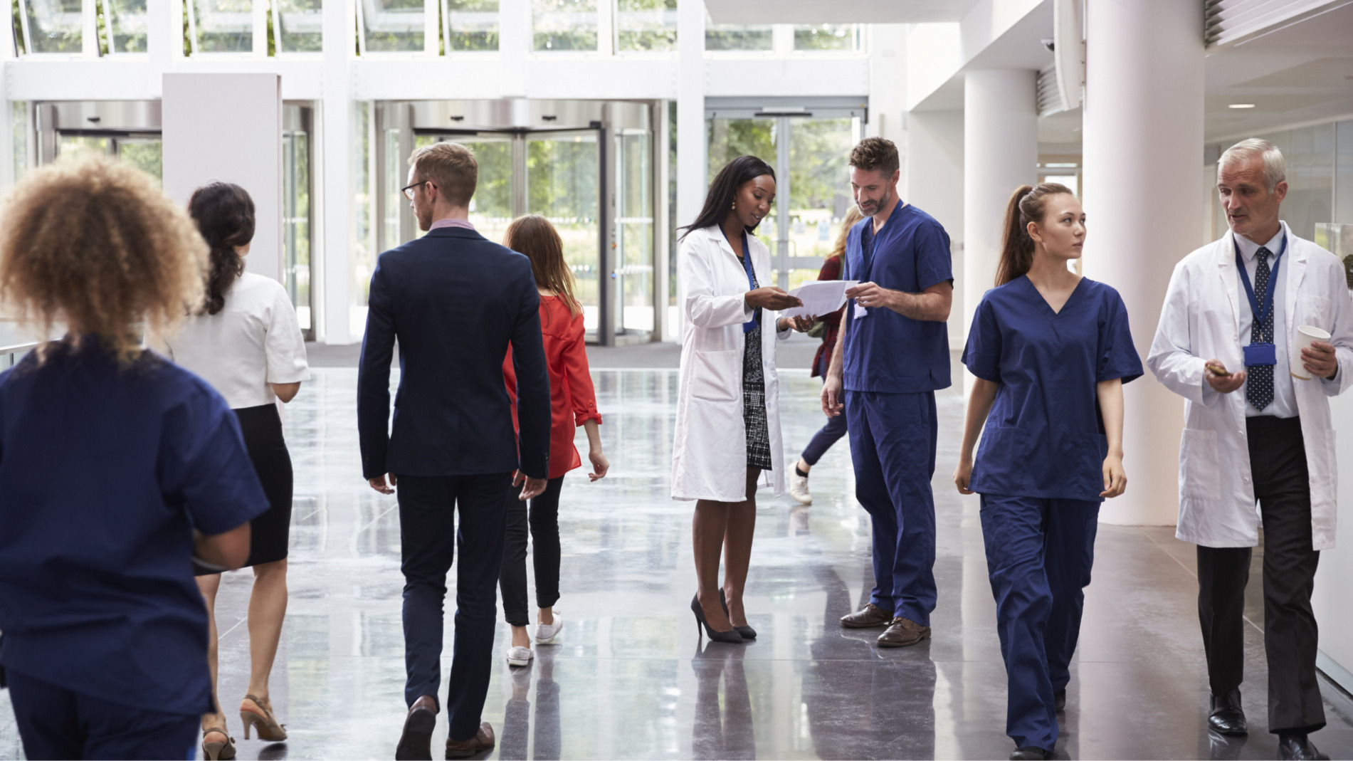 The lobby of a medical center with people going through.